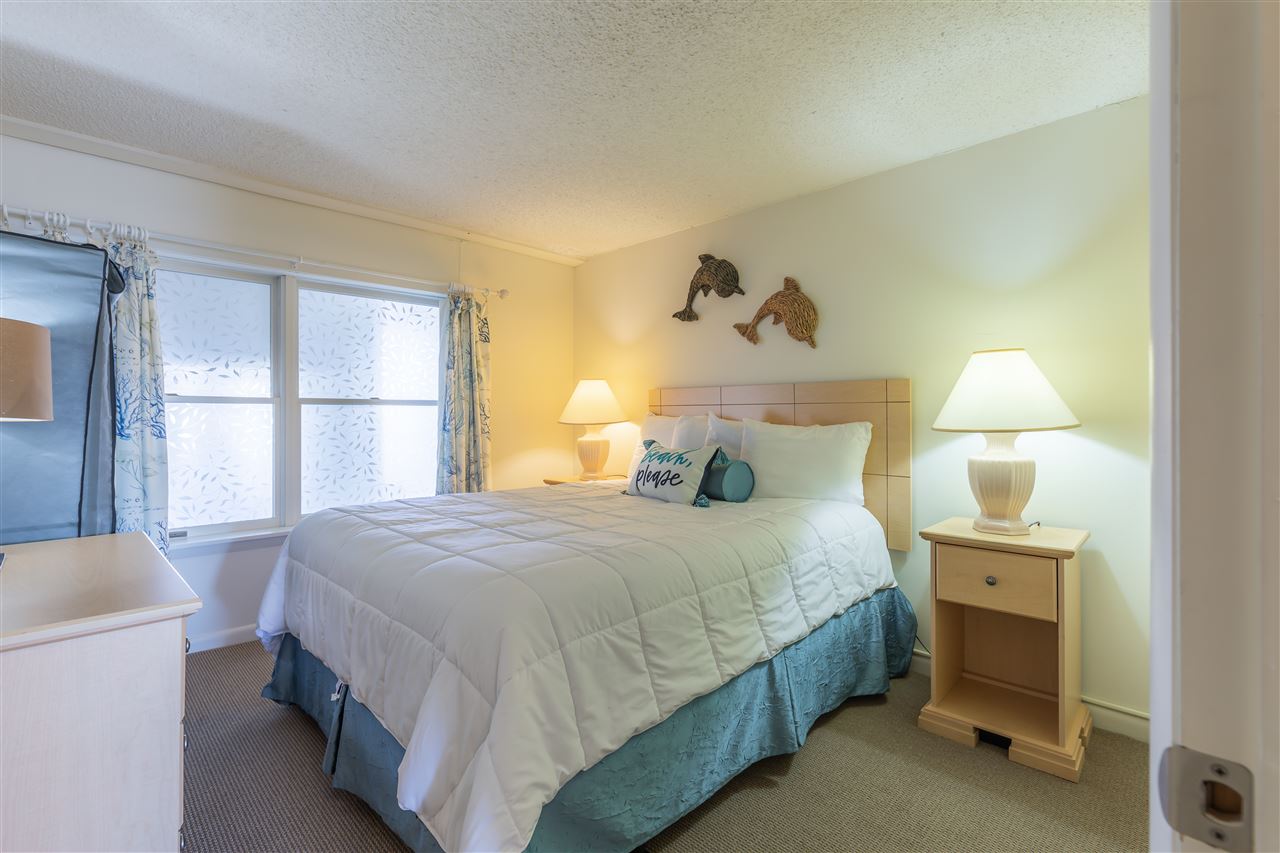 217 Beach, Unit 102 Cape May, NJ 08204 - Photo 16 of 30 a bedroom with a bed and a window
