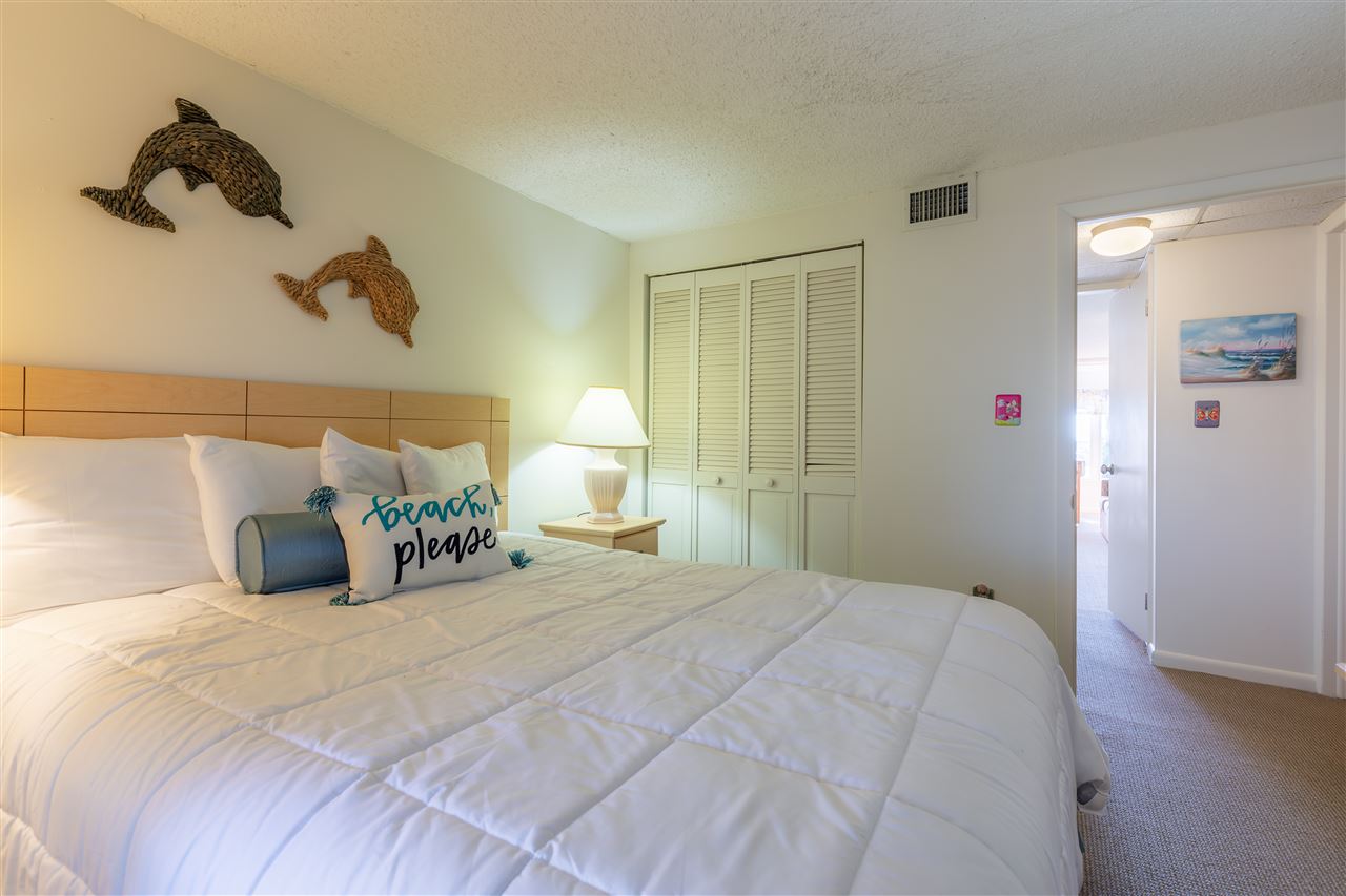 217 Beach, Unit 102 Cape May, NJ 08204 - Photo 17 of 30 a bedroom with a bed and a walk in closet