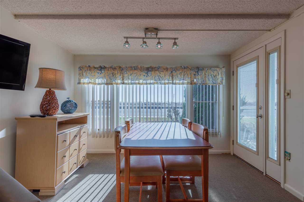 217 Beach, Unit 102 Cape May, NJ 08204 - Photo 9 of 30 a view of a dining room with furniture window and wooden floor