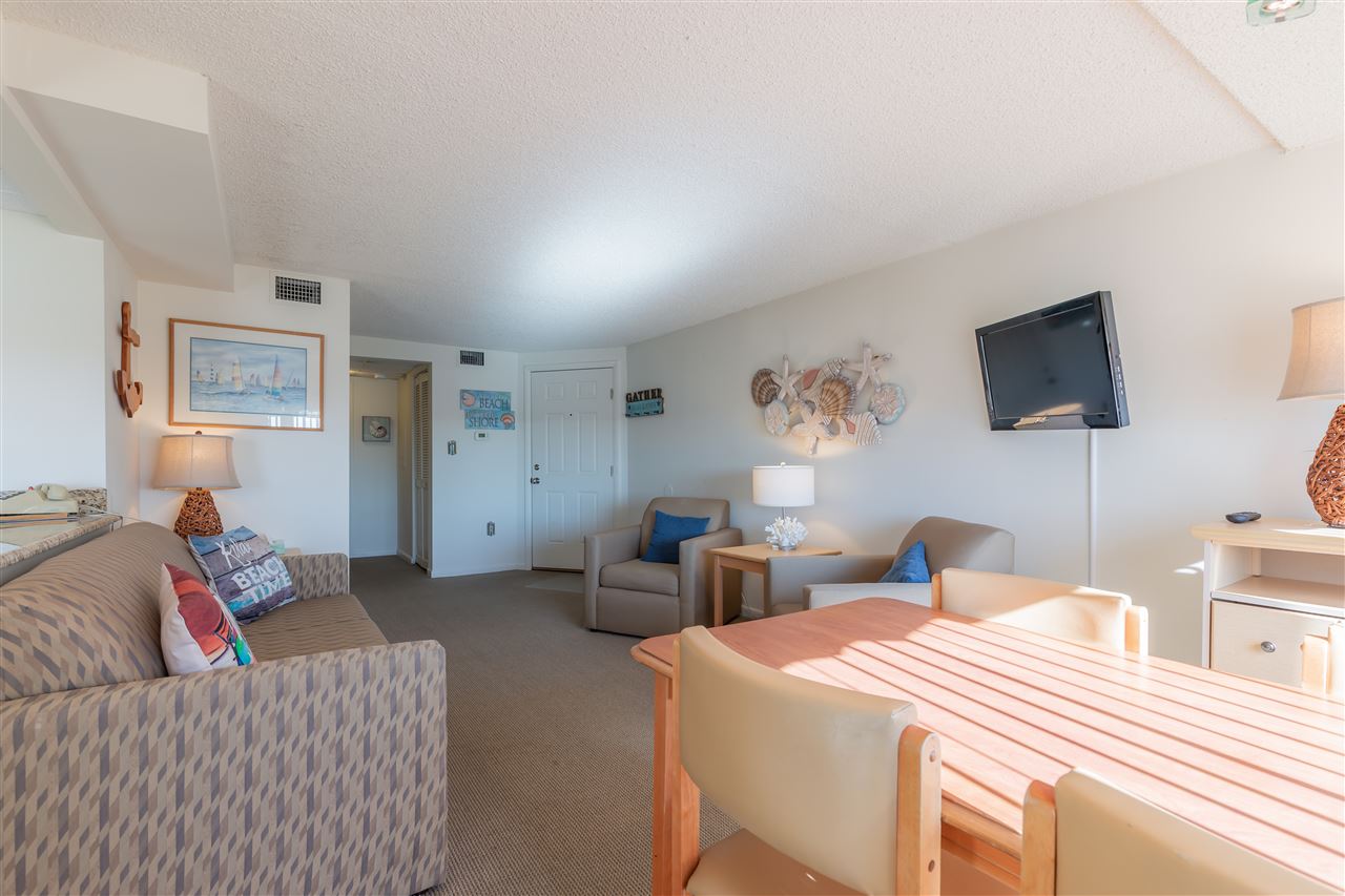 217 Beach, Unit 102 Cape May, NJ 08204 - Photo 10 of 30 a bedroom with a bed and a flat screen tv