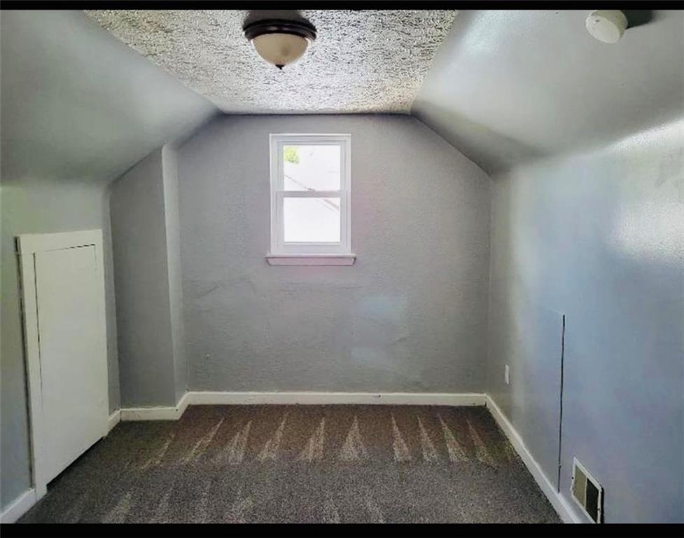 169 Union Street Bridgeville, PA 15017 - Photo 18 of 23 a view of an empty room with wooden floor and a window