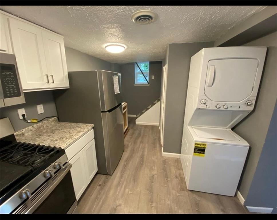 169 Union Street Bridgeville, PA 15017 - Photo 4 of 23 a kitchen with granite countertop a stove and a refrigerator
