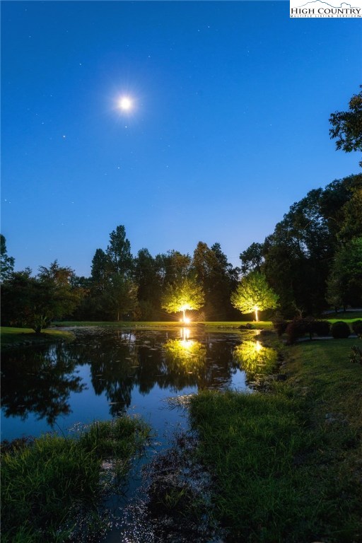 81 Adkins Farm Road Spruce Pine, NC 28777 - Photo 21 of 37 a sunset view with a lake view