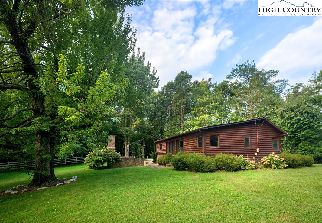 81 Adkins Farm Road Spruce Pine, NC 28777 - Photo 29 of 37 a view of a backyard with potted plants and large trees