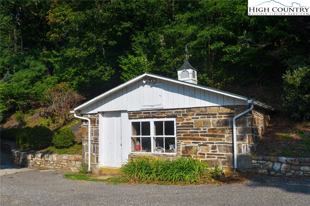 81 Adkins Farm Road Spruce Pine, NC 28777 - Photo 32 of 37 a front view of a house with a yard and garage