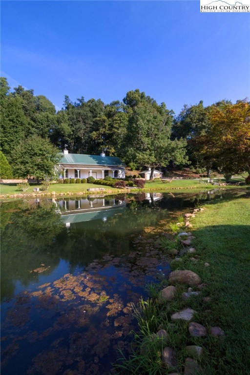 81 Adkins Farm Road Spruce Pine, NC 28777 - Photo 36 of 37 a view of a lake with a yard