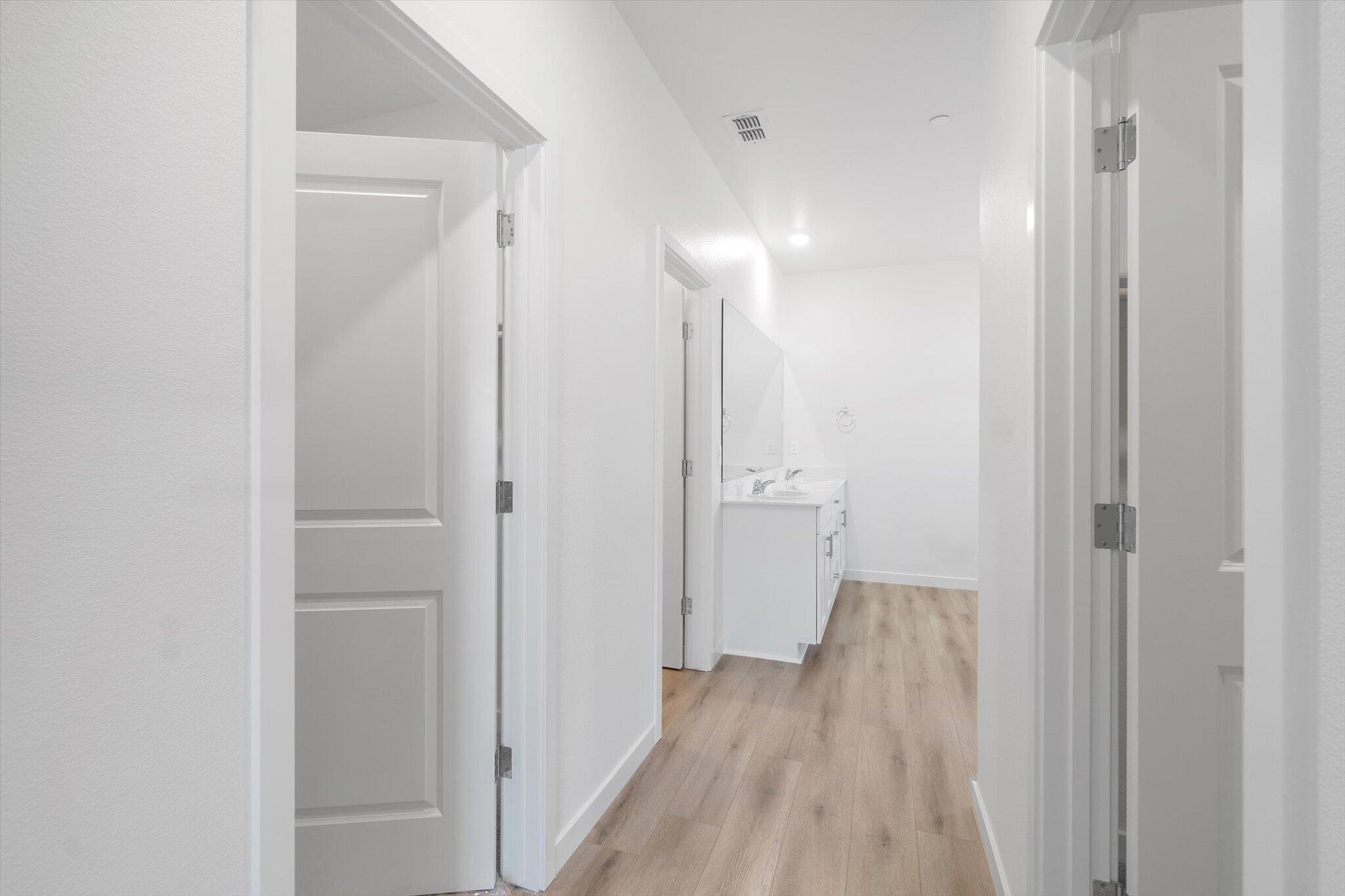 5555 Feathers Avenue Redding, CA 96002 - Photo 12 of 31 a view of a hallway with wooden floor
