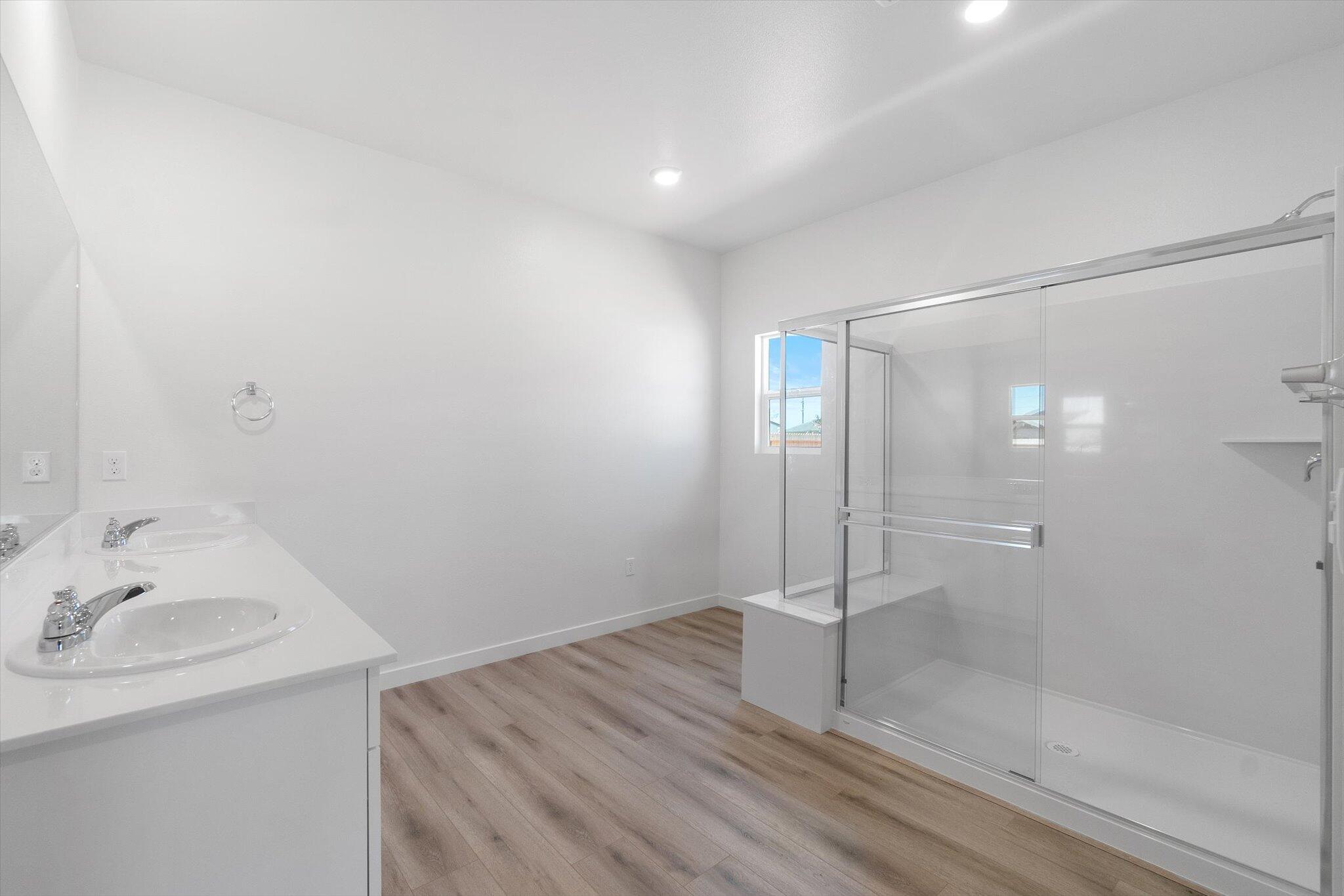 5555 Feathers Avenue Redding, CA 96002 - Photo 14 of 31 a bathroom with a sink and shower