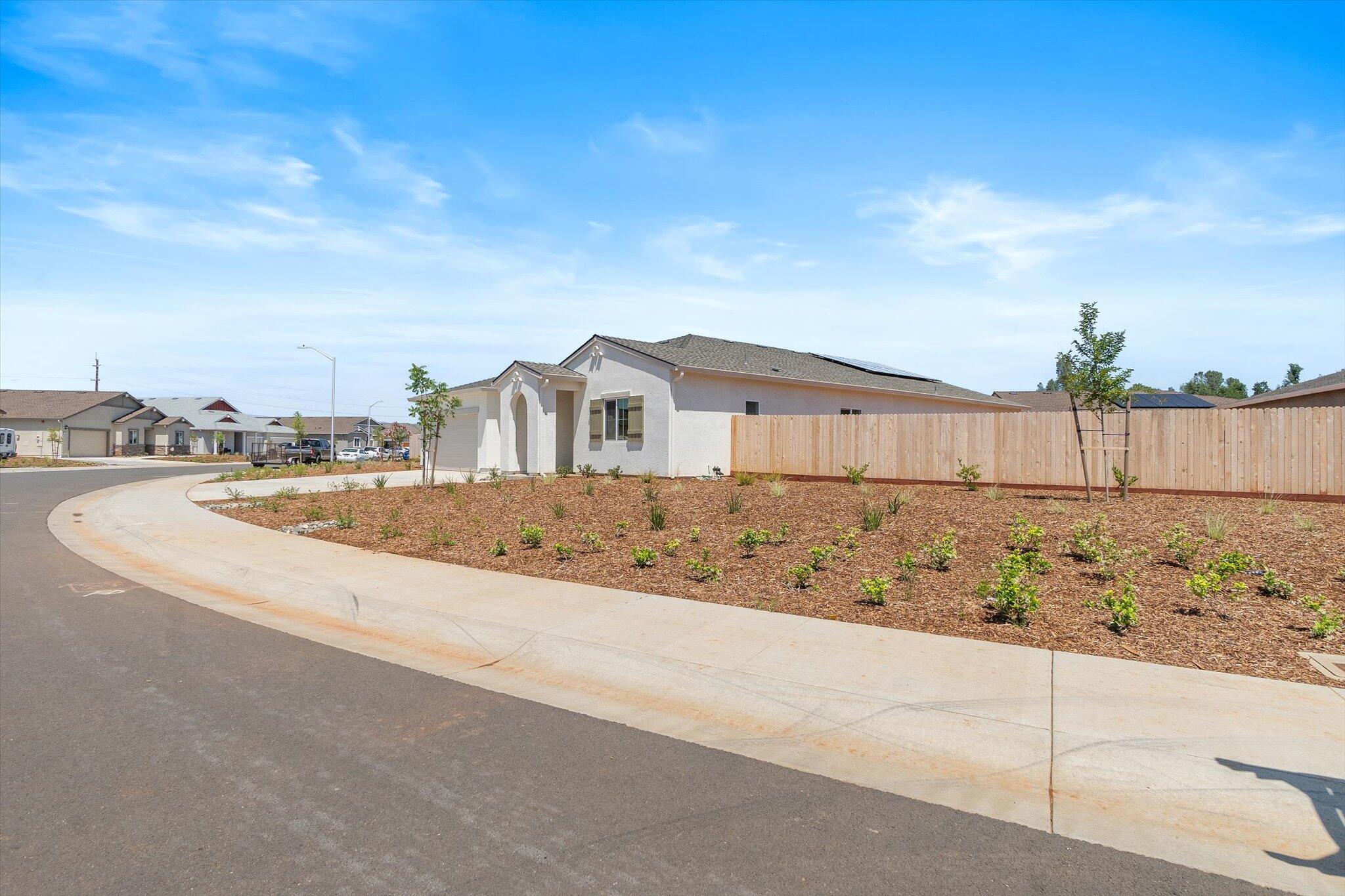 5555 Feathers Avenue Redding, CA 96002 - Photo 29 of 31 a view of house with yard and ocean view