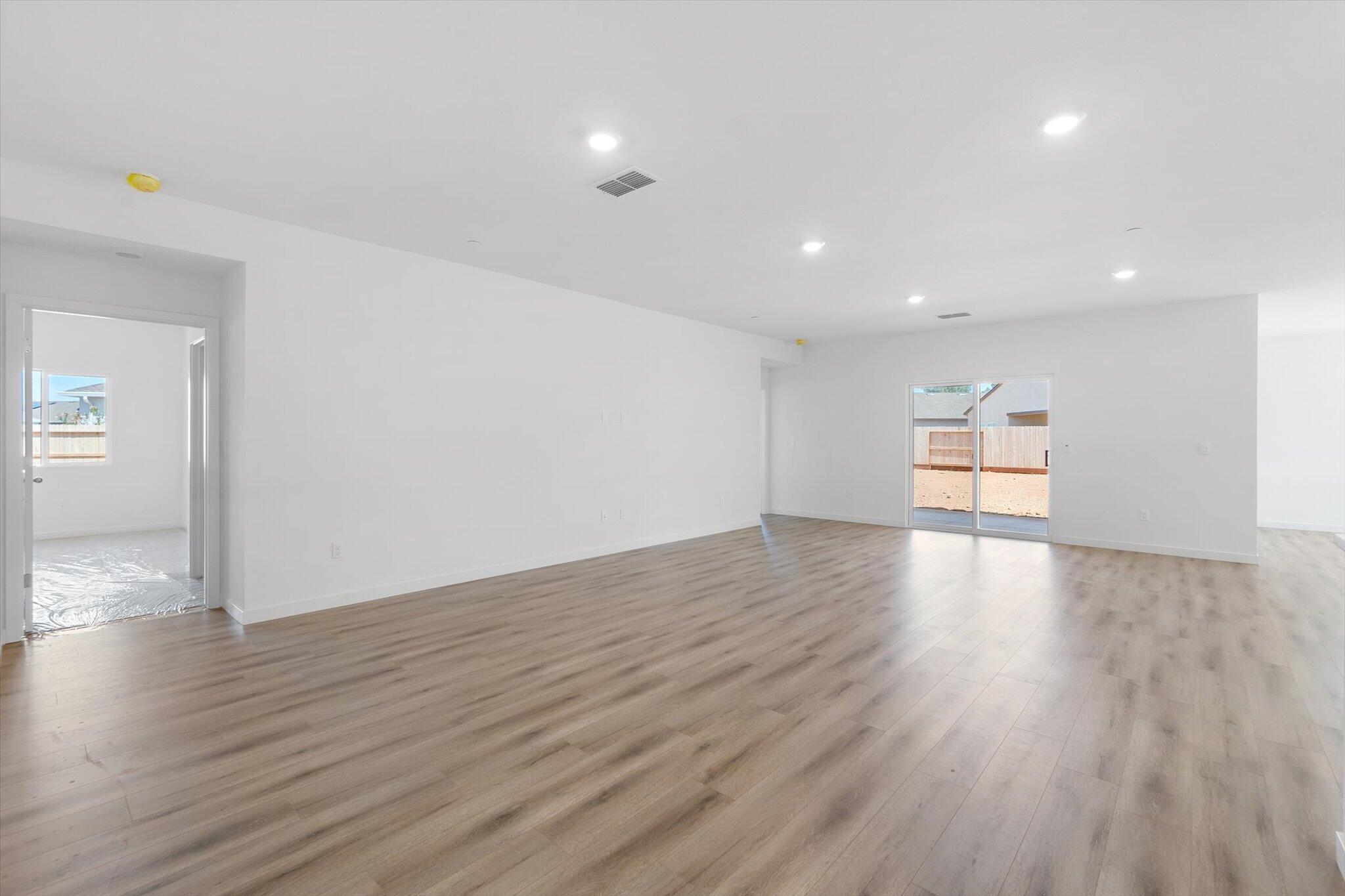 5555 Feathers Avenue Redding, CA 96002 - Photo 4 of 31 a view of empty room with wooden floor