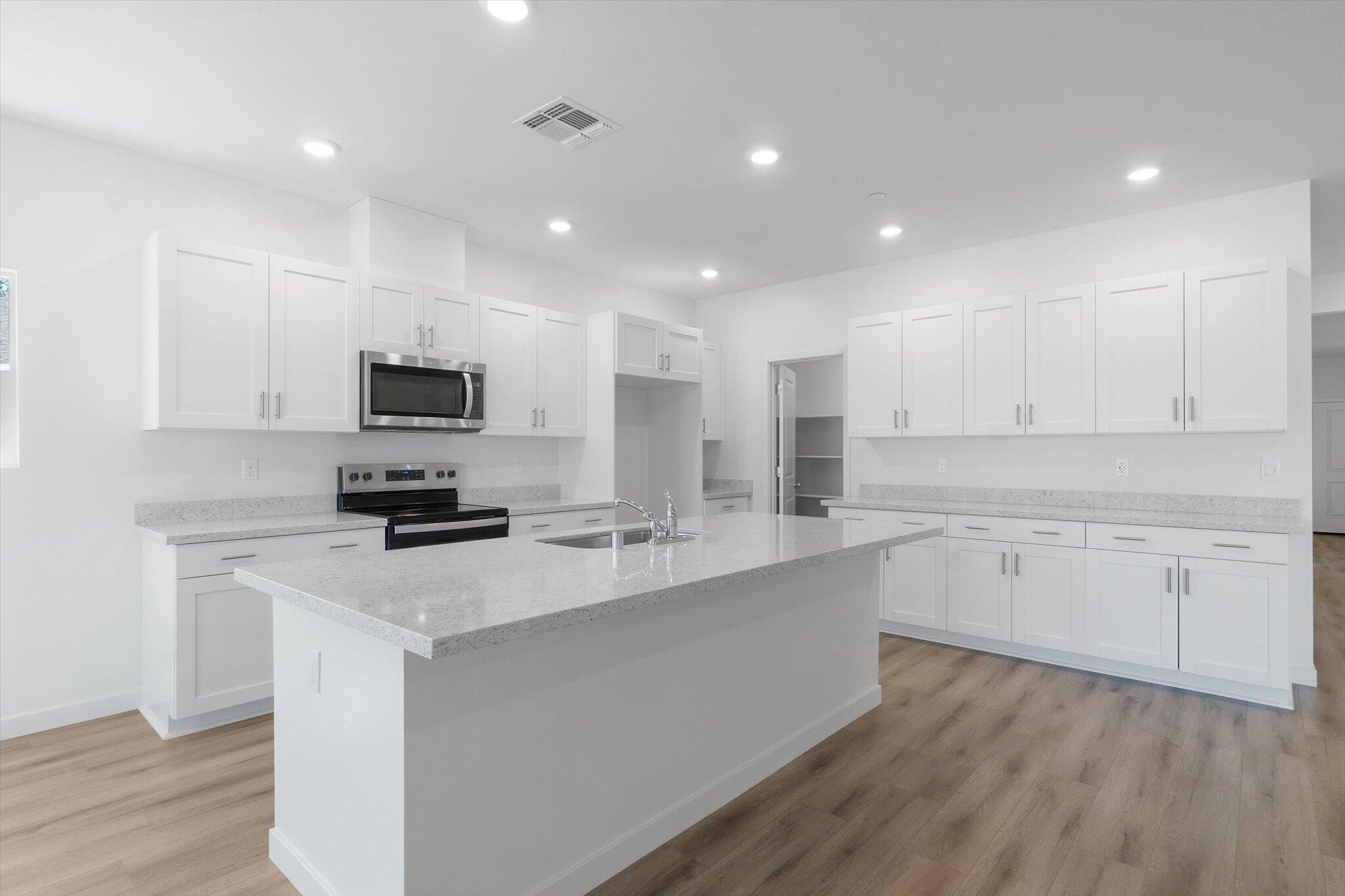 5555 Feathers Avenue Redding, CA 96002 - Photo 5 of 31 a kitchen with appliances a sink and cabinets