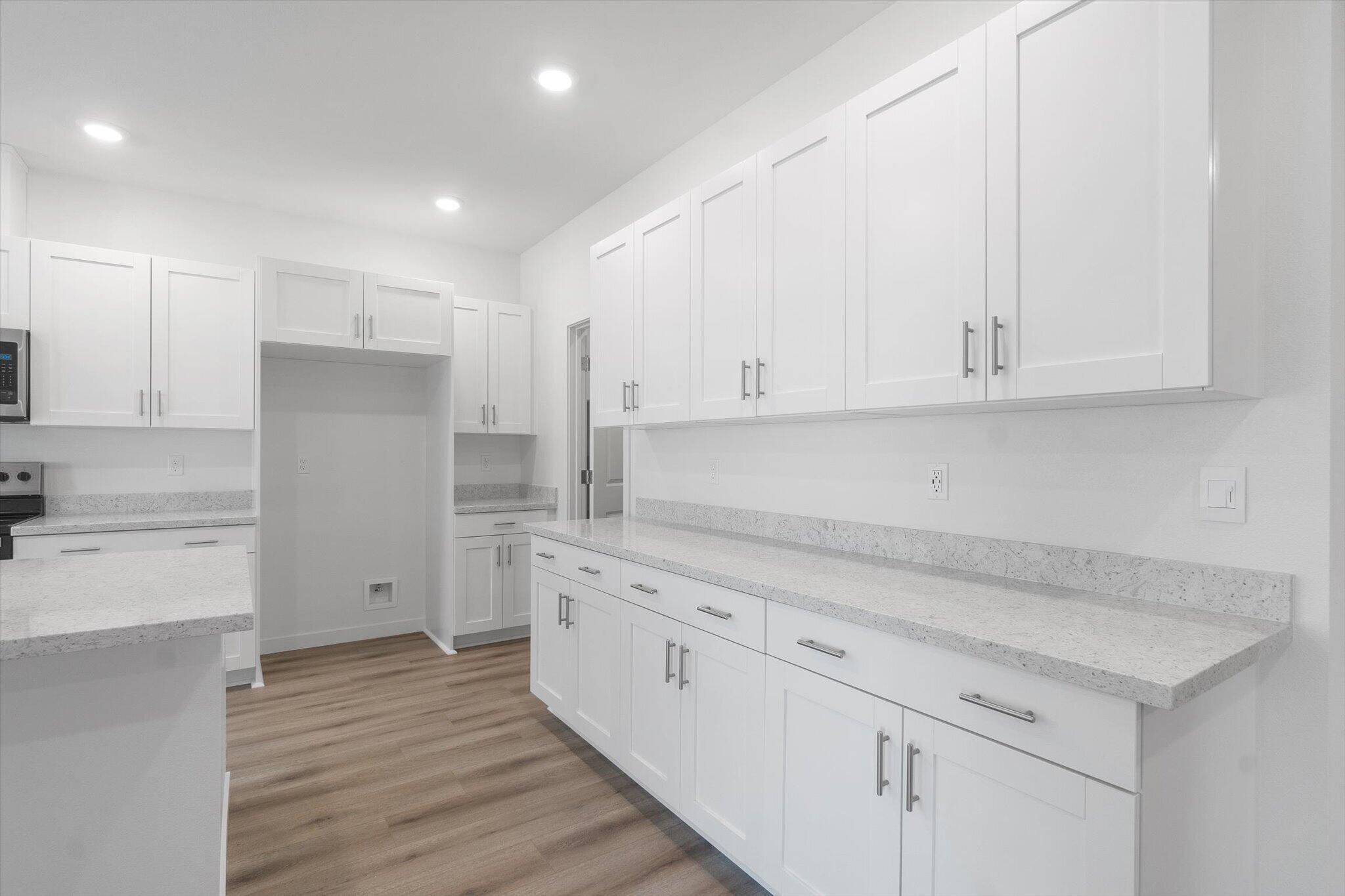 5555 Feathers Avenue Redding, CA 96002 - Photo 7 of 31 a kitchen with white cabinets and sink