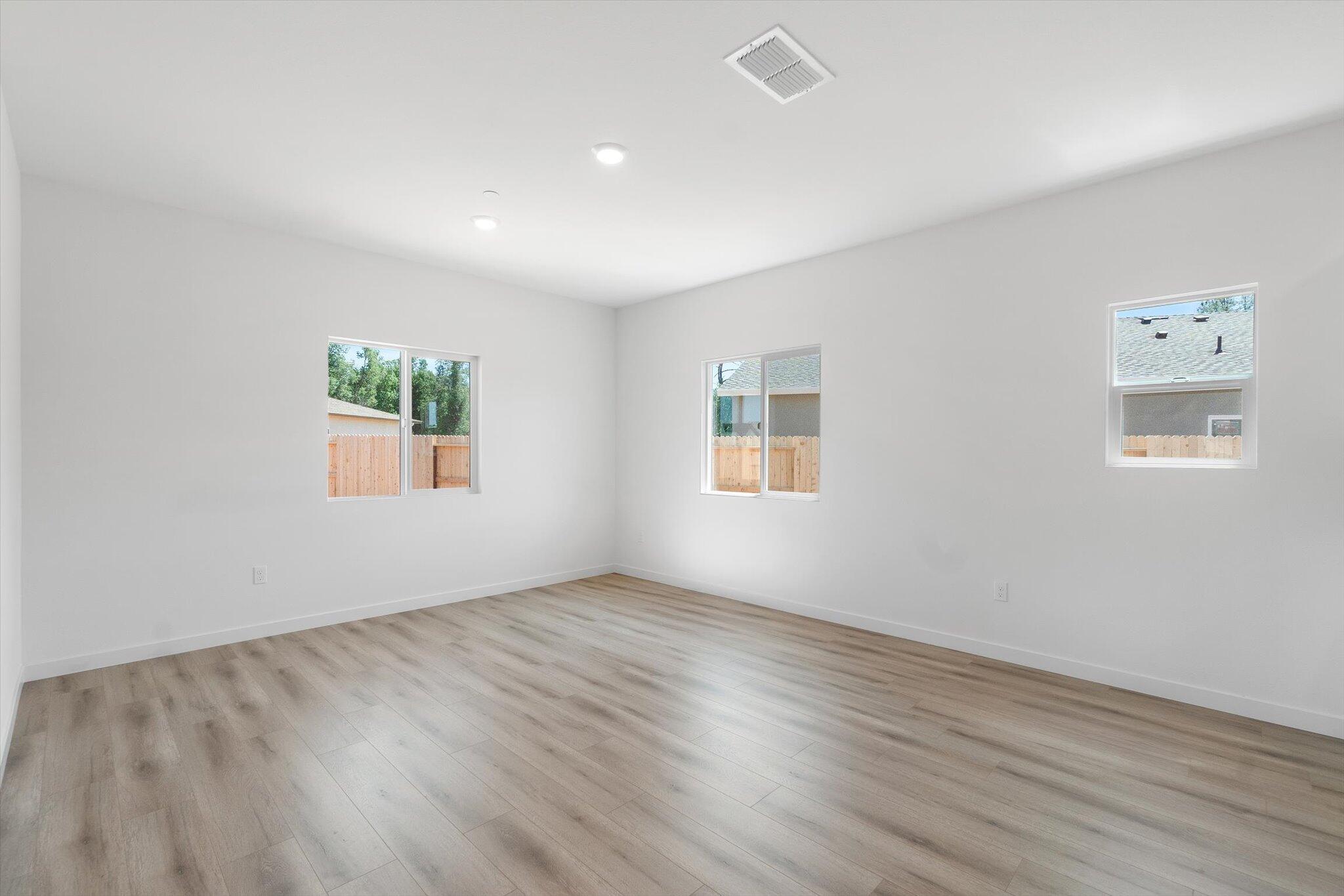 5555 Feathers Avenue Redding, CA 96002 - Photo 8 of 31 a view of an empty room with wooden floor and a window