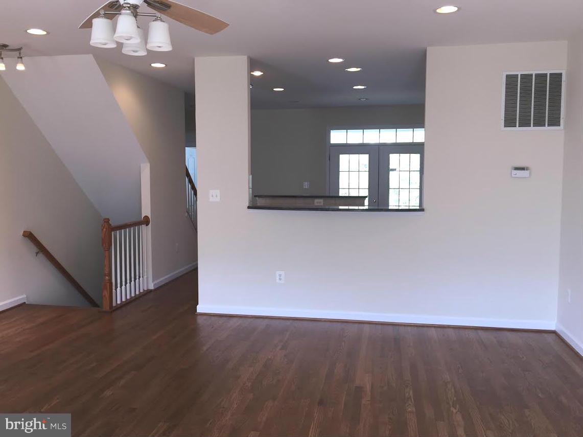 708 Redgate Lane Woodbridge, VA 22191 - Photo 5 of 20 an empty room with wooden floor and windows