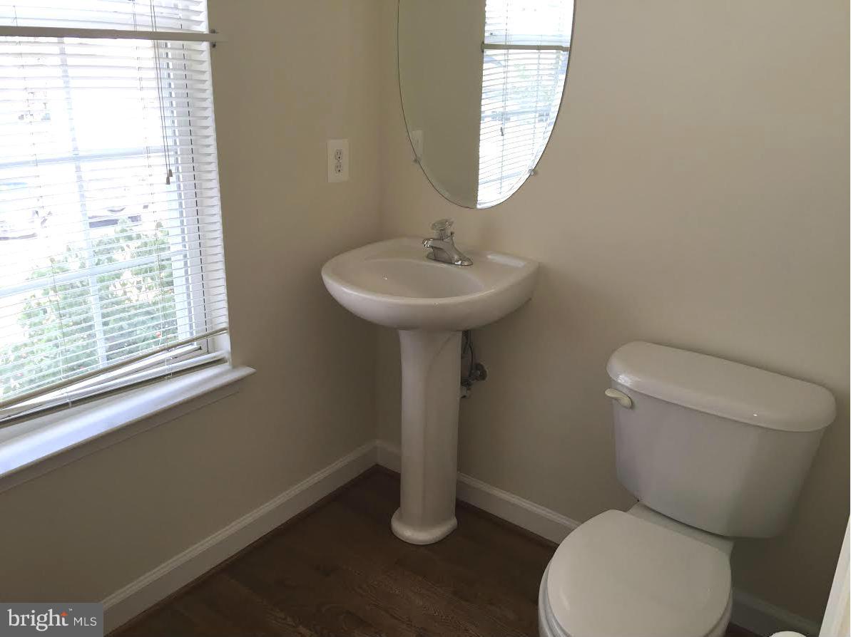 708 Redgate Lane Woodbridge, VA 22191 - Photo 10 of 20 a bathroom with a toilet sink and window