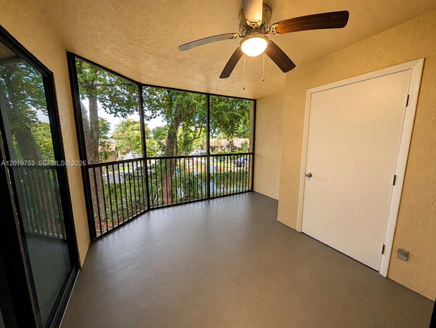 3410 Foxcroft Road, Unit 206 Miramar, FL 33025 - Photo 19 of 23 an empty room with windows and outdoor view