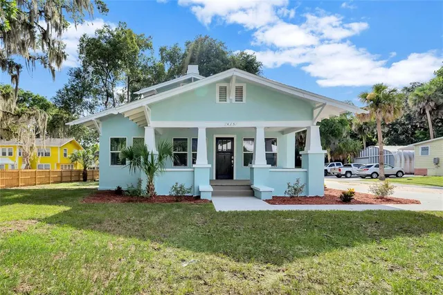 a front view of a house with a yard and porch