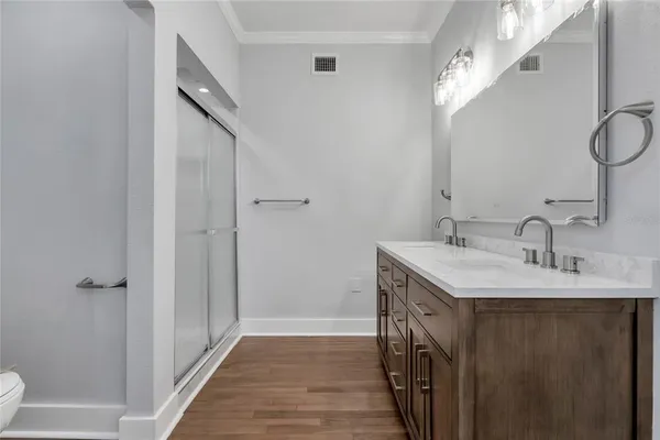 a bathroom with 2 sink and a mirror