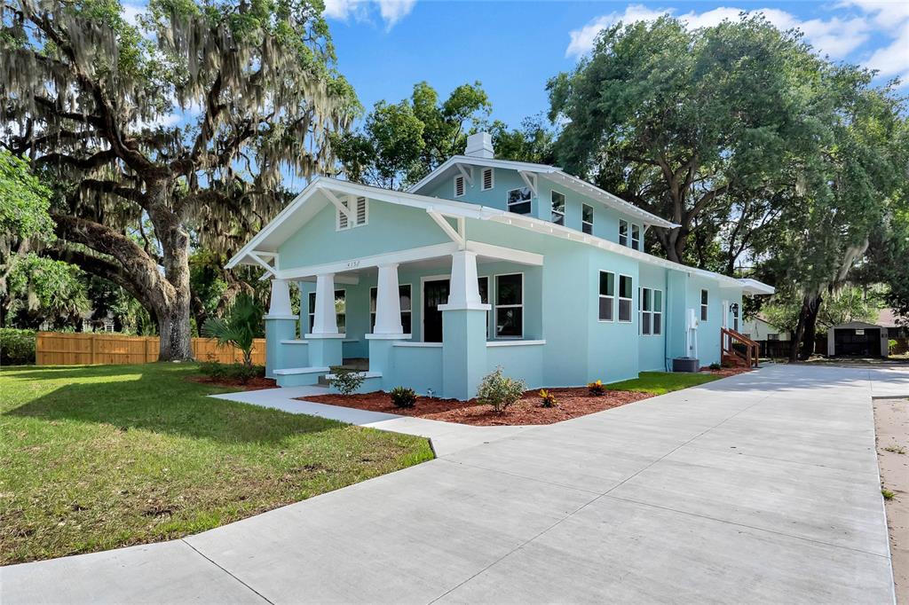 415 South 9th Street Leesburg, FL 34748 - Photo 2 of 37 a front view of a house with a yard and trees