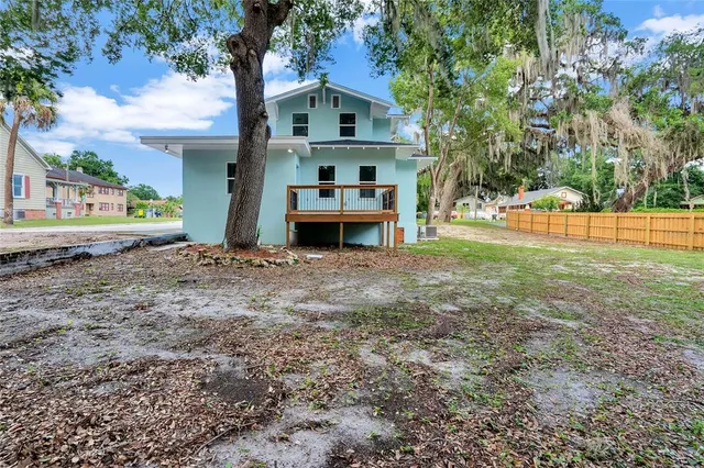 a view of a house with a yard and sitting area