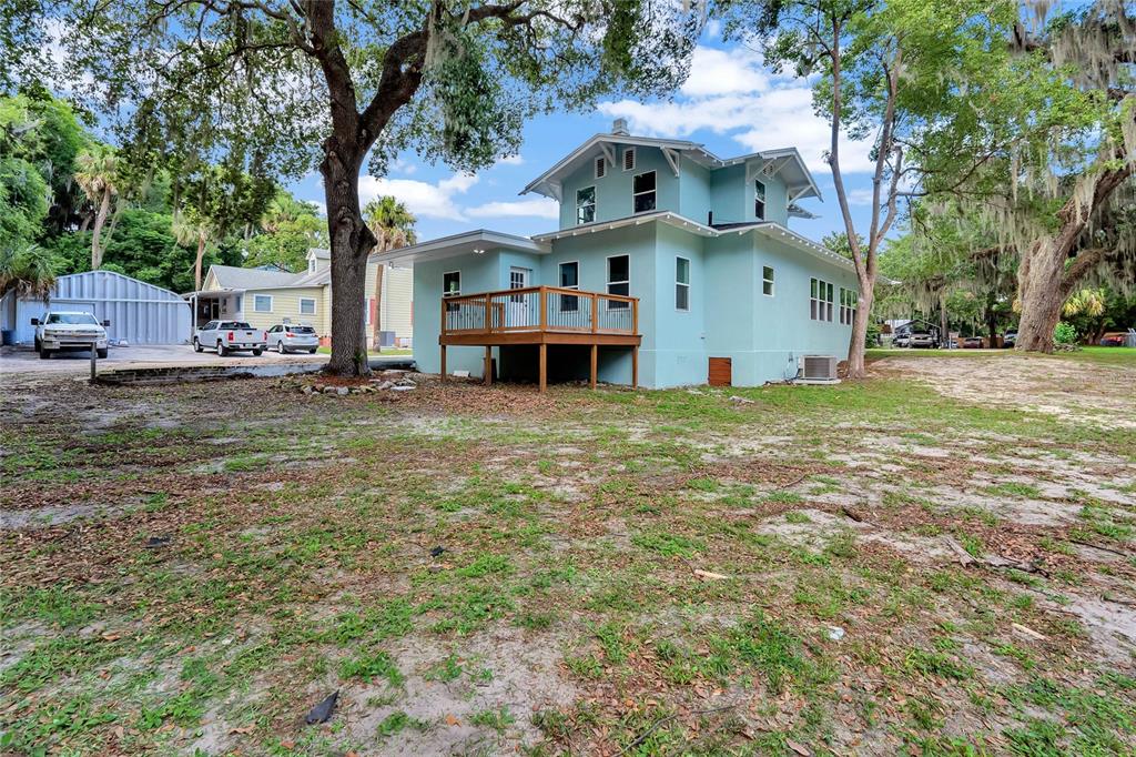 415 South 9th Street Leesburg, FL 34748 - Photo 35 of 37 a view of a house with a yard and sitting area