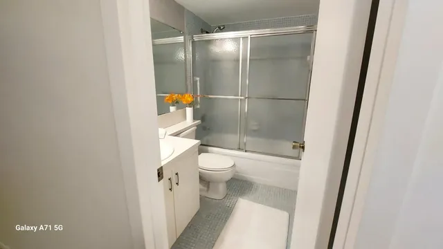 a bedroom with a bed a couch and a window