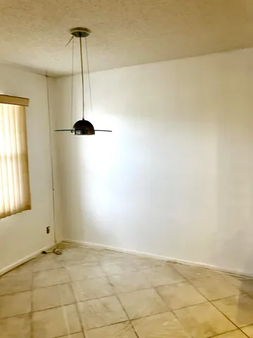 a view of an empty room and a window