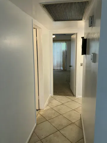 an empty room with a ceiling fan and a window