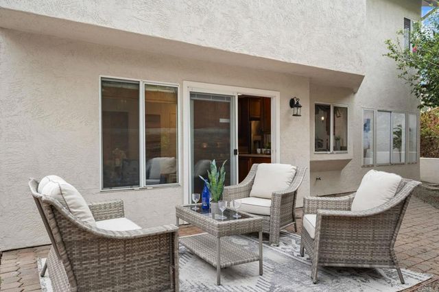 a view of a patio with couches chairs and potted plants