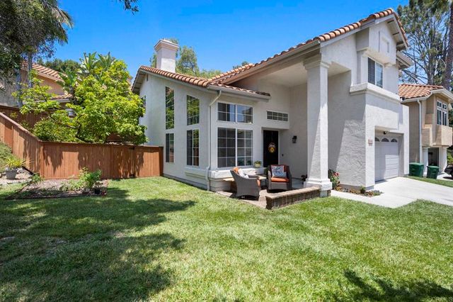 a view of a house with backyard sitting area and garden