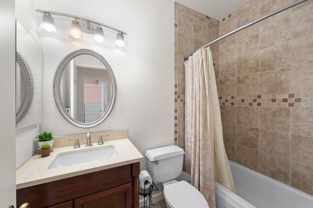 a bathroom with a sink a mirror a toilet and a bathtub