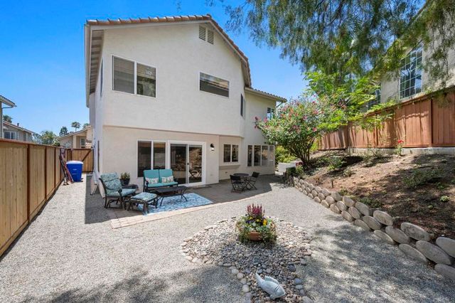 a wooden bench sitting in front of a house