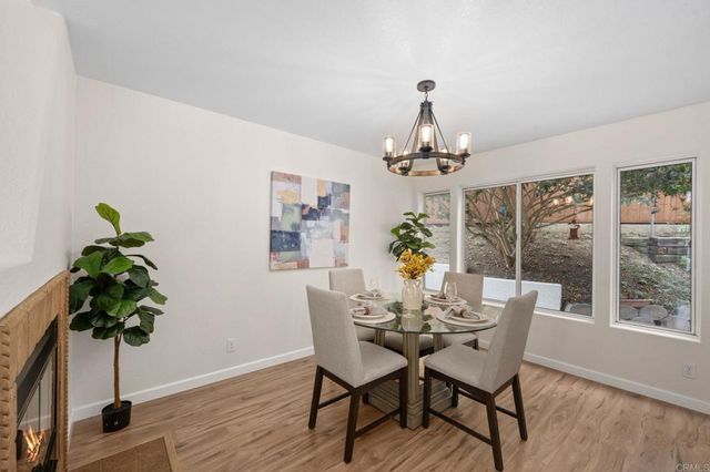 a dining room with furniture potted plants and wooden floor