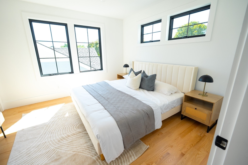 20 Crescent Road, Unit 20 Needham, MA 02494 - Photo 7 of 33 a bedroom with a bed and a large window