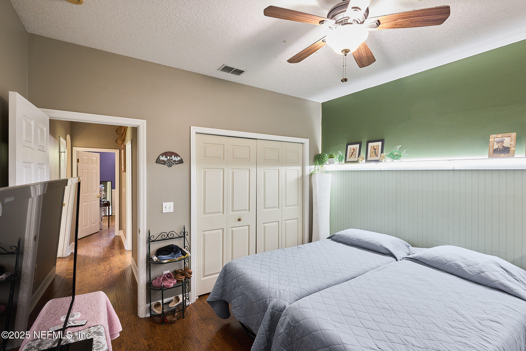 54262 Spring Lake Drive Callahan, FL 32011 - Photo 22 of 44 a bedroom with a bed and a chandelier