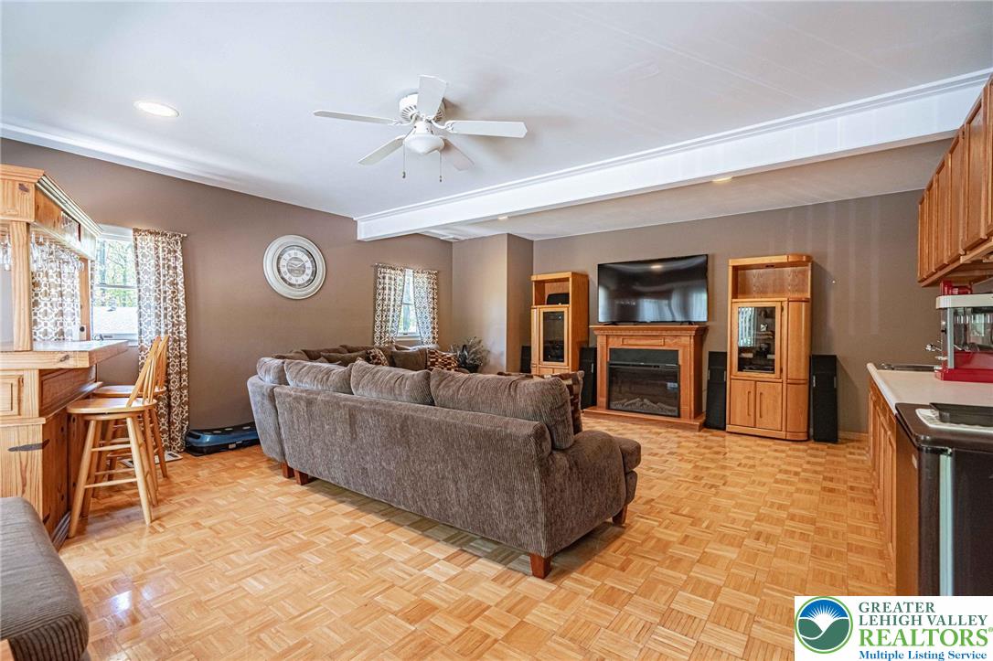 3857 Friedens Road Slatington, PA 18080 - Photo 19 of 75 This inviting living space features beautiful flooring and a cozy fireplace, perfect for gatherings.