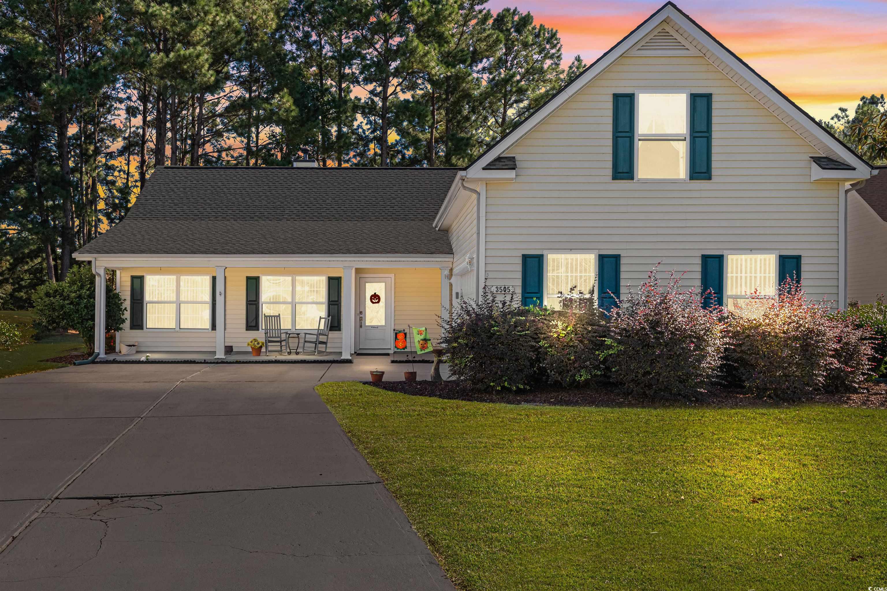 3505 Arrowhead Boulevard Myrtle Beach, SC 29579 - Photo 2 of 40 Traditional-style house with a yard, covered porch, driveway, and a shingled roof