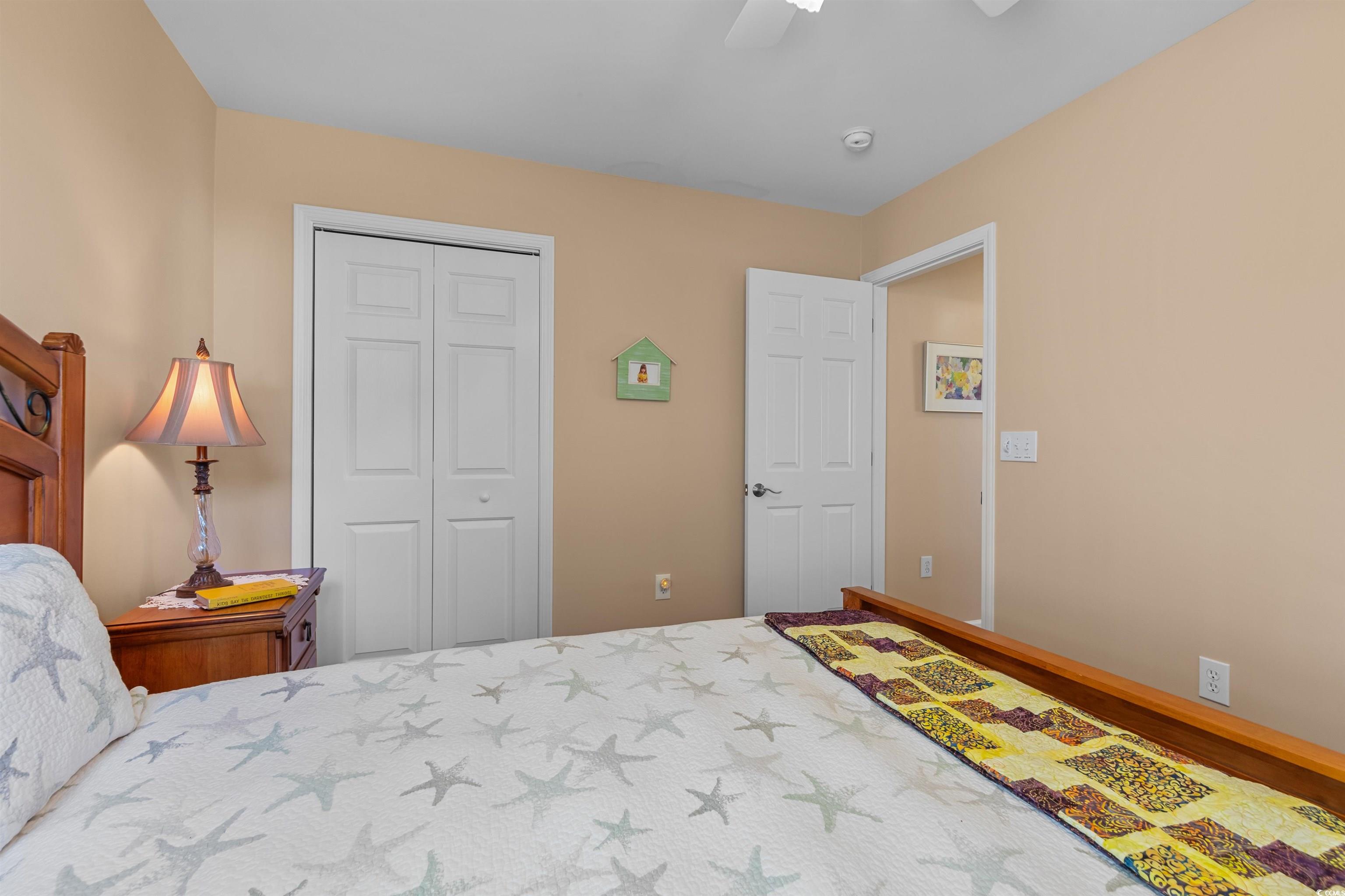 3505 Arrowhead Boulevard Myrtle Beach, SC 29579 - Photo 24 of 40 Bedroom featuring a ceiling fan, a closet, and wood finished floors