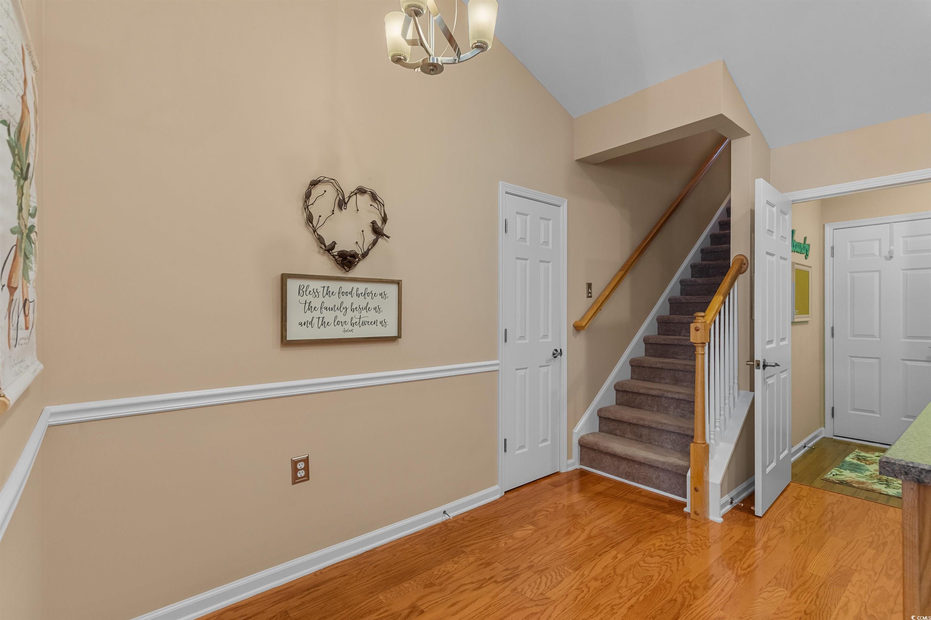 3505 Arrowhead Boulevard Myrtle Beach, SC 29579 - Photo 25 of 40 Foyer with stairs, light wood-style flooring, and a chandelier