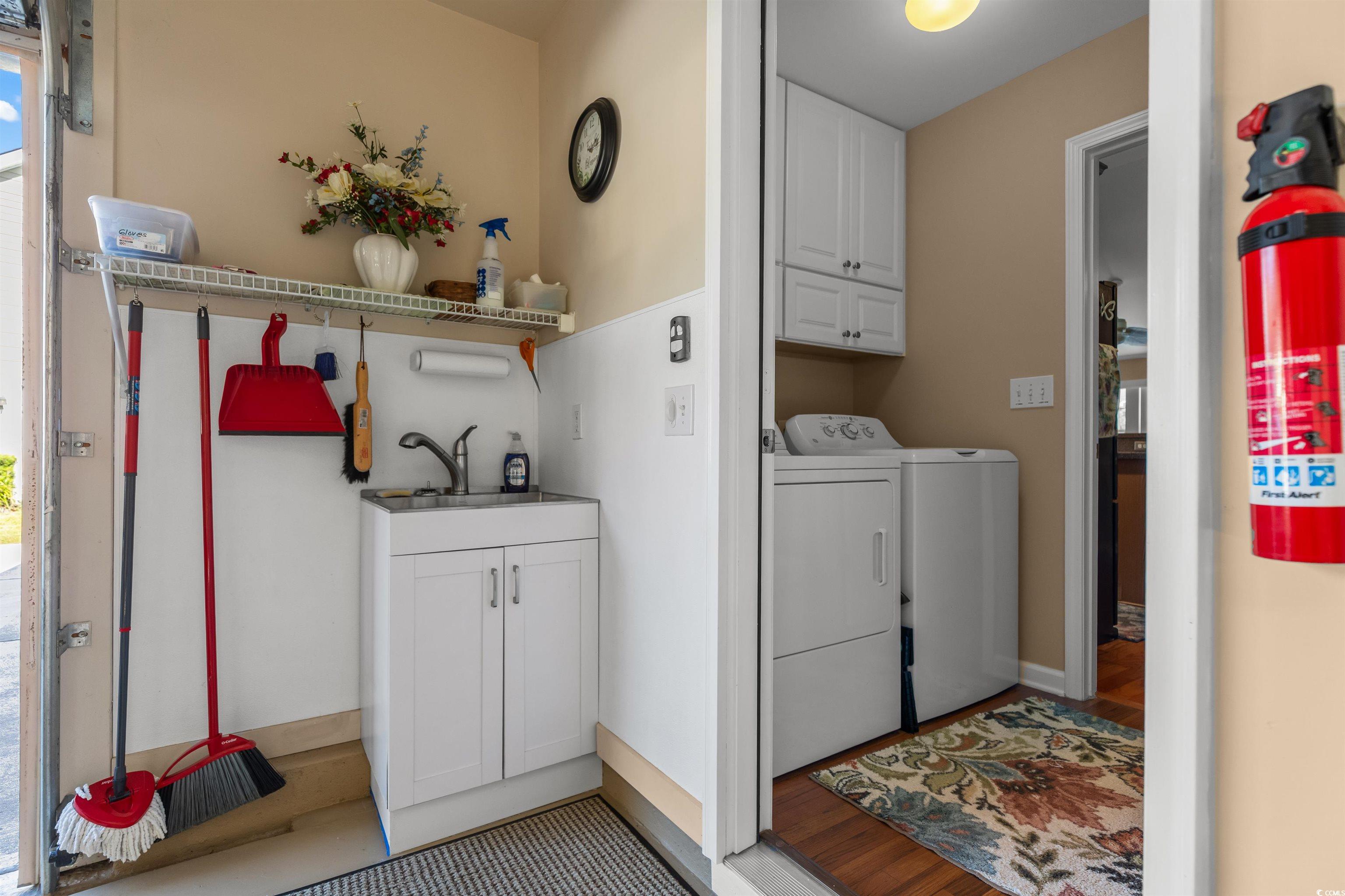 3505 Arrowhead Boulevard Myrtle Beach, SC 29579 - Photo 31 of 40 Laundry room featuring cabinet space, light wood finished floors, and washer and clothes dryer