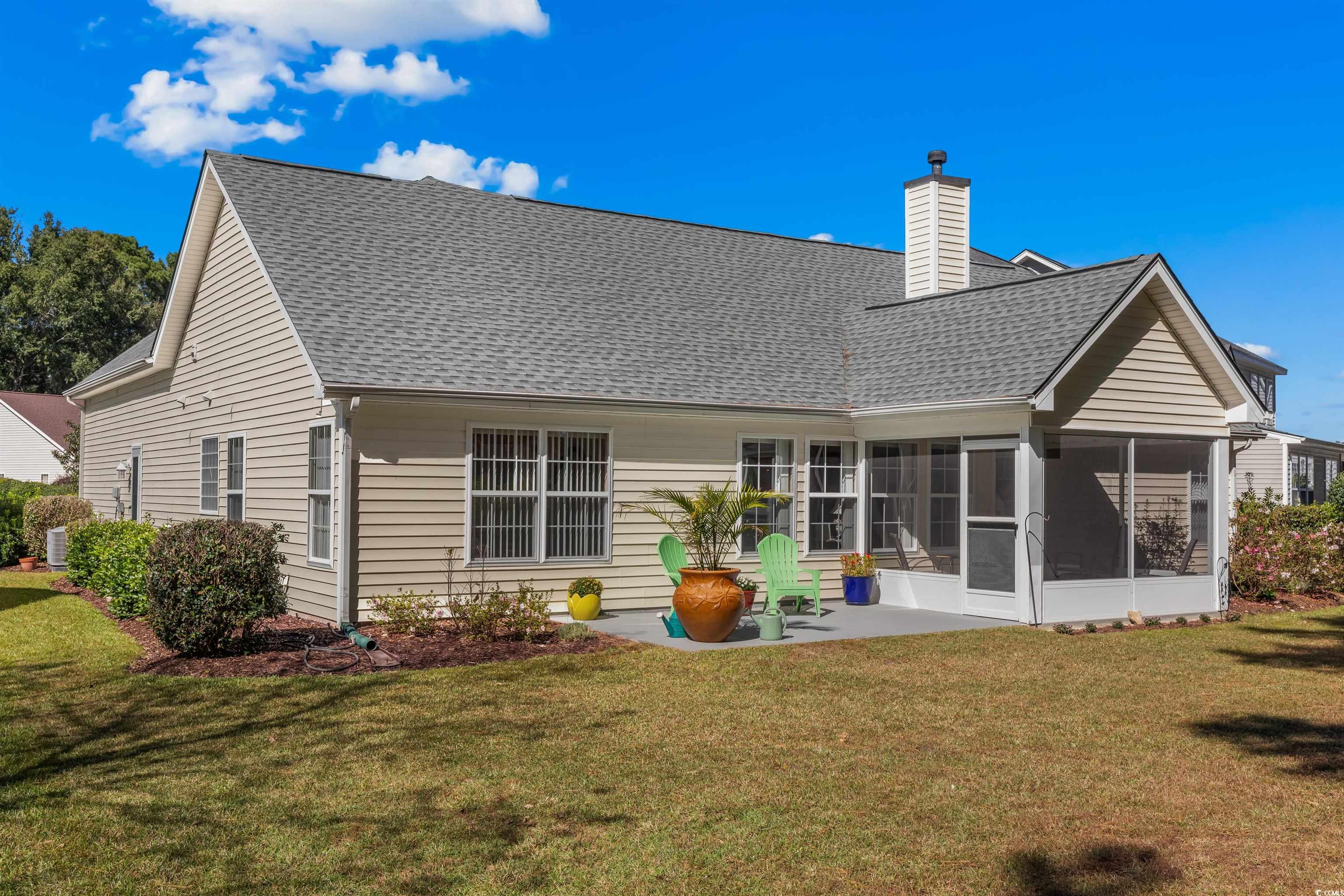 3505 Arrowhead Boulevard Myrtle Beach, SC 29579 - Photo 37 of 40 Back of house featuring a sunroom, a yard, and a chimney