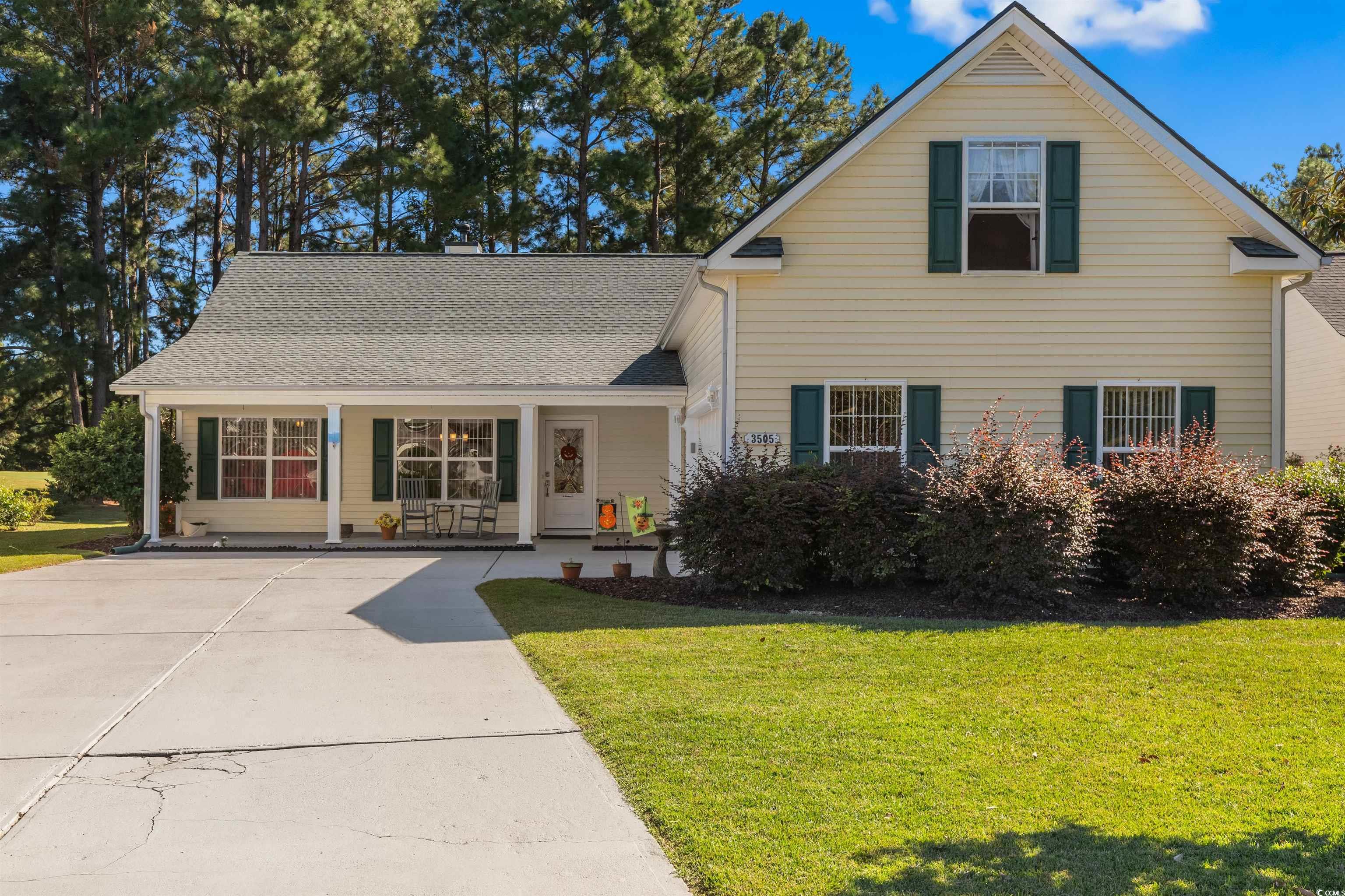 3505 Arrowhead Boulevard Myrtle Beach, SC 29579 - Photo 40 of 40 Traditional-style home featuring a front lawn, a porch, concrete driveway, and a shingled roof
