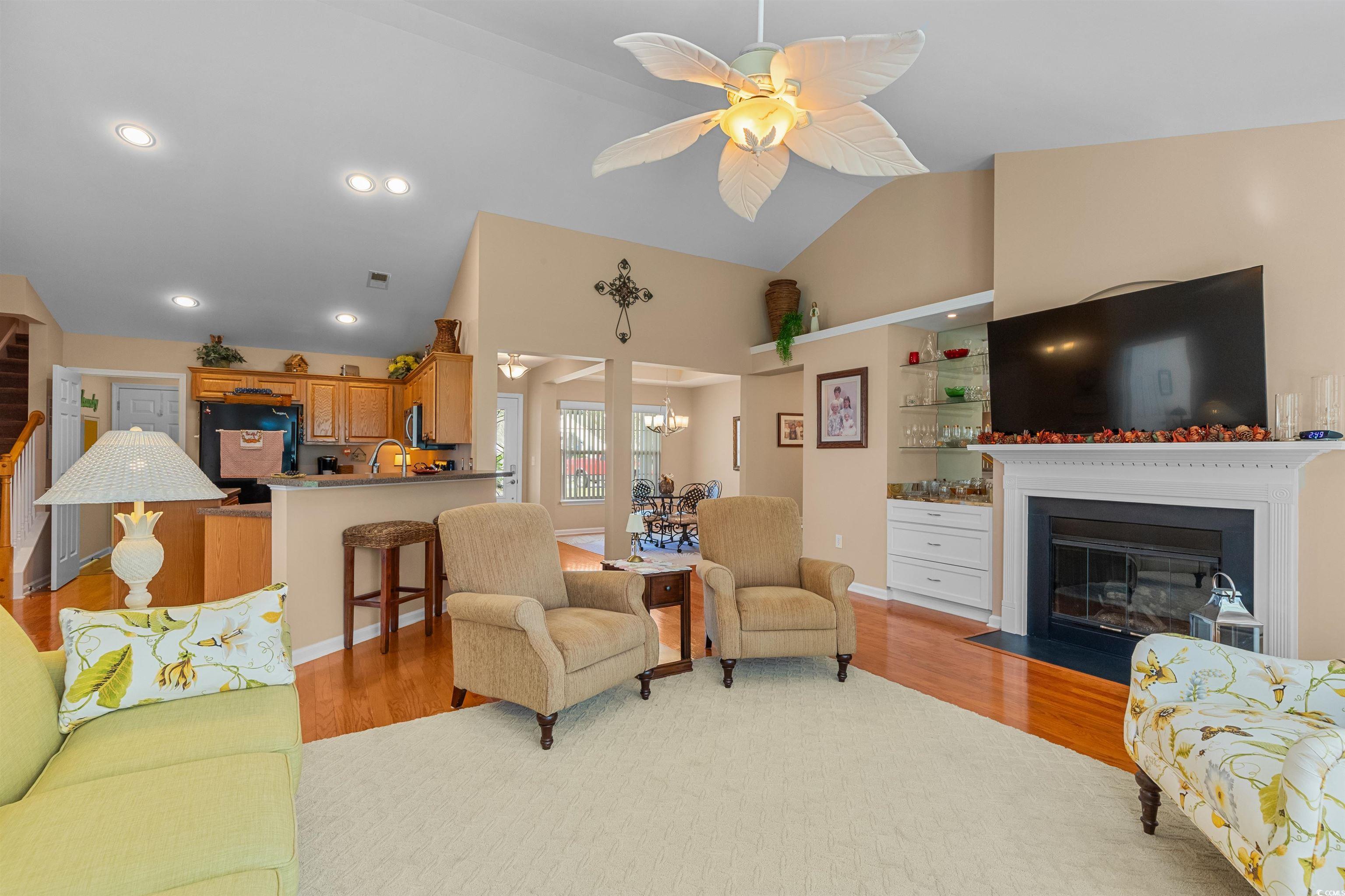 3505 Arrowhead Boulevard Myrtle Beach, SC 29579 - Photo 9 of 40 Living area with light wood-type flooring, recessed lighting, a ceiling fan, a fireplace with flush hearth, and a chandelier