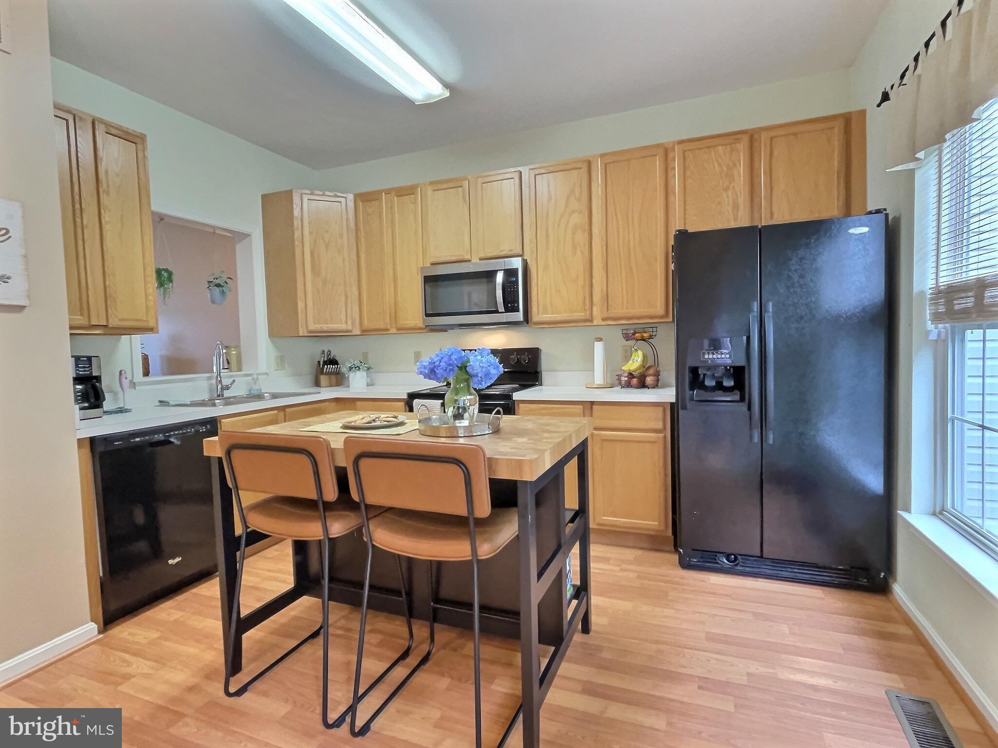 42 Highland Circle Newark, DE 19713 - Photo 5 of 19 a kitchen with stainless steel appliances granite countertop a refrigerator a sink a stove a microwave and a refrigerator
