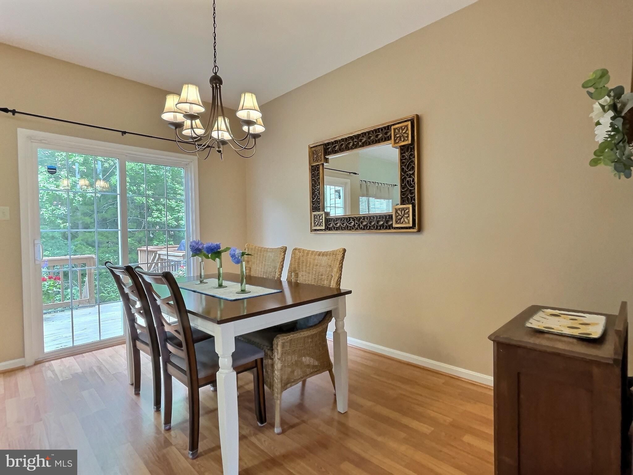 42 Highland Circle Newark, DE 19713 - Photo 7 of 19 a view of a dining room with furniture a chandelier and wooden floor