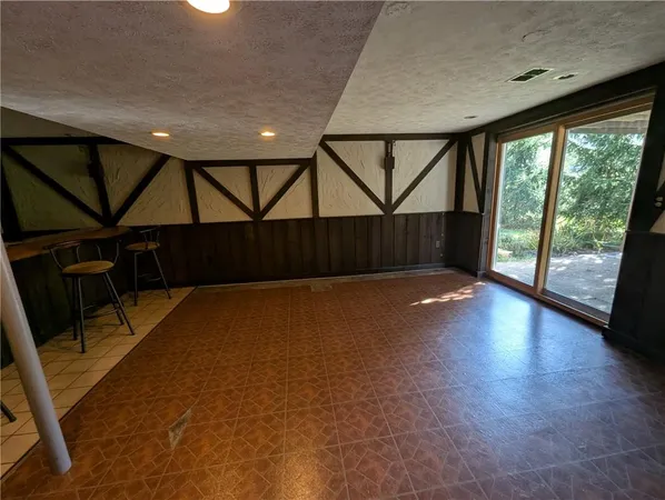 a view of a room with wooden floor and windows