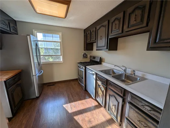 a kitchen with wooden floors and a sink