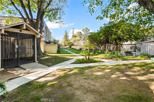 a view of a house with backyard and a tree