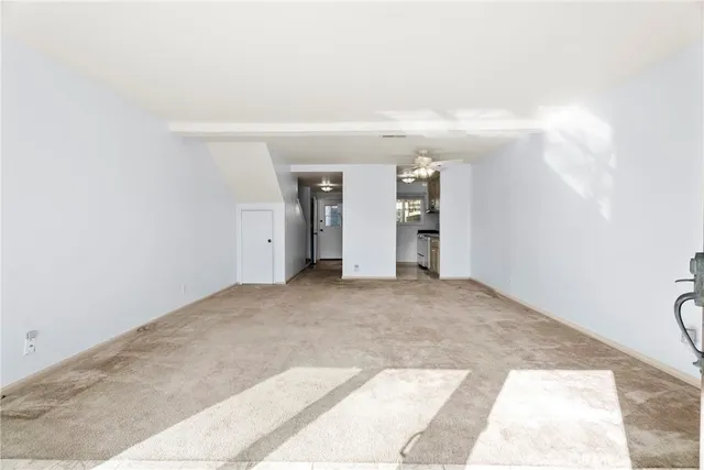 an empty room with closet and windows