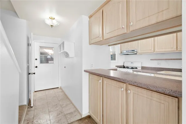 a kitchen with granite countertop a sink and cabinets